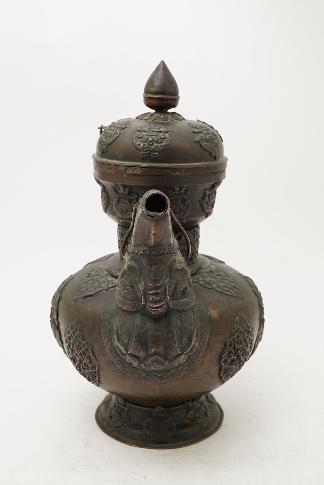 A large Tibetan repoussé brass and copper ewer, 19th century